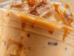 Caramel poured over a tall glass of iced salted caramel coffee